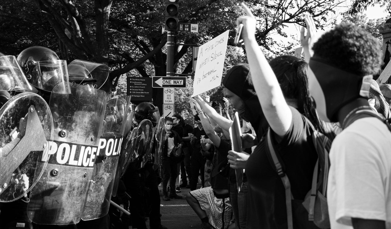 A line of protesters faces a line of cops. We need antiracist leadership now.